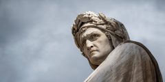 Closeup shot of the famous white marble monument of Dante Alighieri by  Enrico Pazzi in Piazza Santa Croce, next to Basilica of Santa Croce, Florence, Italy on a moody sky background